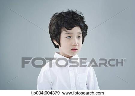 Stock Photo - a boy looking confused . Fotosearch