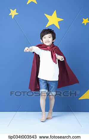 a boy posing like a superman with a red cape around his neck View Large Photo Image Stock Image - a boy posing like a superman with a red cape around his neck. Fotosearch
