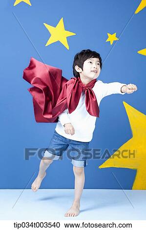 a boy posing like a superman with fluttering red cape View Large Photo Image Stock Image - a boy posing like a superman with fluttering red cape. Fotosearch