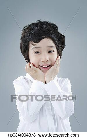 a boy posing with his hands on chin View Large Photo Image Stock Photo - a boy posing with his hands on chin. Fotosearch