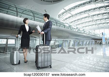 a businessman and woman discussing in Incheon airport View Large Photo Image Stock Photo - a businessman and woman discussing in Incheon airport. Fotosearch
