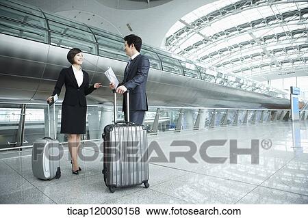 a businessman and woman discussing in Incheon airport View Large Photo Image Stock Photo - a businessman and woman discussing in Incheon airport. Fotosearch