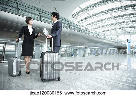Stock Photography - a businessman and woman discussing in Incheon airport. Fotosearch