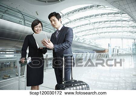 a businessman and woman discussing with document in Incheon airport View Large Photo Image Stock Image - a businessman and woman discussing with document in Incheon airport. Fotosearch