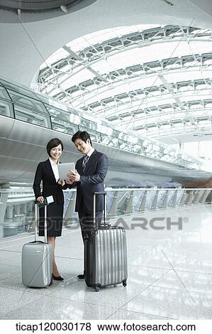 a businessman and woman discussing with document in Incheon airport View Large Photo Image Stock Photo - a businessman and woman discussing with document in Incheon airport. Fotosearch