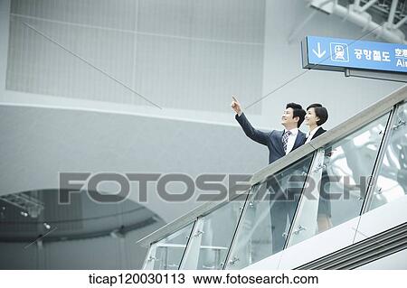 Stock Image - a businessman and woman in Incheon airport. Fotosearch