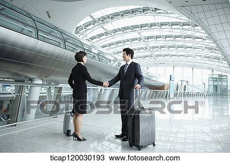 a businessman and woman shaking hands in Incheon airport View Large Photo Image Stock Image - a businessman and woman shaking hands in Incheon airport. Fotosearch