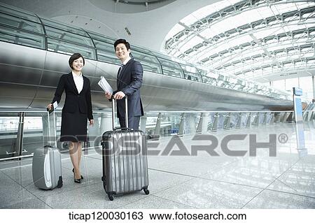 a businessman and woman smiling at camera in Incheon airport View Large Photo Image Stock Image - a businessman and woman smiling at camera in Incheon airport. Fotosearch