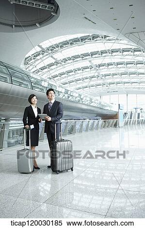 a businessman and woman standing with luggage in Incheon airport View Large Photo Image Stock Photography - a businessman and woman standing with luggage in Incheon airport. Fotosearch