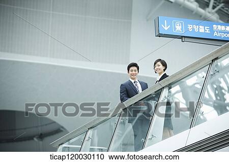 a businessman and woman talking in Incheon airport View Large Photo Image Stock Image - a businessman and woman talking in Incheon airport. Fotosearch