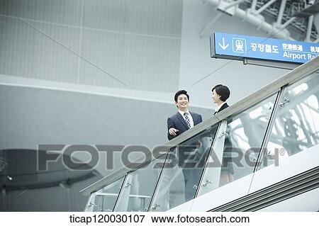 a businessman and woman talking in Incheon airport View Large Photo Image Stock Photo - a businessman and woman talking in Incheon airport. Fotosearch