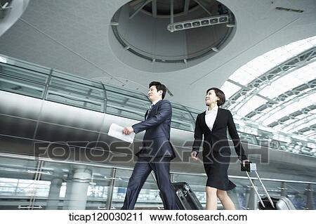 a businessman and woman walking fast in Incheon airport View Large Photo Image Stock Image - a businessman and woman walking fast in Incheon airport. Fotosearch