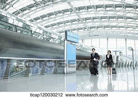 a businessman and woman walking fast in Incheon airport View Large Photo Image Stock Image - a businessman and woman walking fast in Incheon airport. Fotosearch