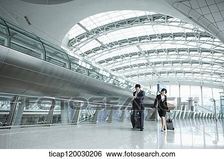 a businessman and woman walking fast in Incheon airport View Large Photo Image Stock Photograph - a businessman and woman walking fast in Incheon airport. Fotosearch