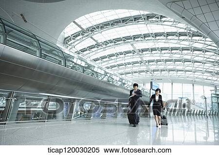a businessman and woman walking fast in Incheon airport View Large Photo Image Stock Photography - a businessman and woman walking fast in Incheon airport. Fotosearch
