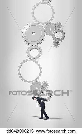 a businessman holding gear set with his back View Large Photo Image Stock Image - a businessman holding gear set with his back. Fotosearch