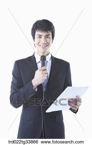 Stock Photograph - a businessman in a black suit making a speech with microphone . Fotosearch