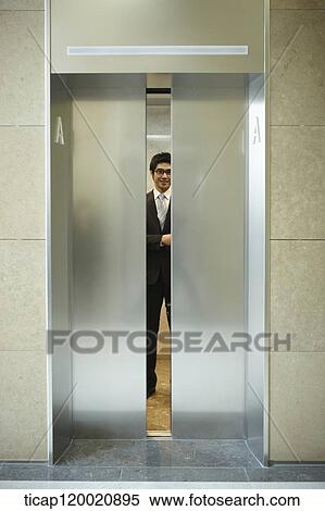 a businessman inside a closing elevator View Large Photo Image Stock Photography - a businessman inside a closing elevator . Fotosearch