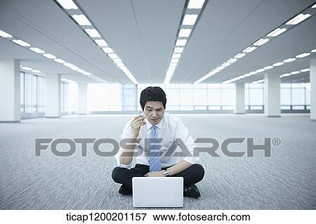 a businessman playing with a pen while using laptop in an empty room View Large Photo Image Stock Photo - a businessman playing with a pen while using laptop in an empty room. Fotosearch