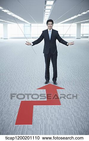 a businessman standing in the end of an arrow in an empty room View Large Photo Image Stock Image - a businessman standing in the end of an arrow in an empty room. Fotosearch