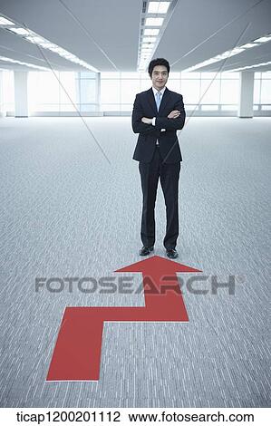 a businessman standing in the end of an arrow in an empty room View Large Photo Image Stock Image - a businessman standing in the end of an arrow in an empty room. Fotosearch