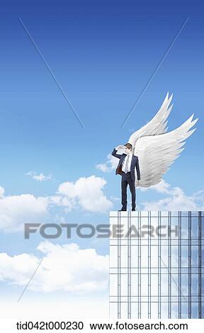 a businessman standing on top of a building with wings in his back View Large Photo Image Stock Image - a businessman standing on top of a building with wings in his back. Fotosearch