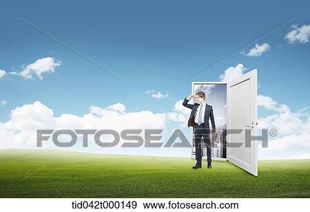 a businessman stepping out of a door to a nature View Large Photo Image Stock Photo - a businessman stepping out of a door to a nature. Fotosearch