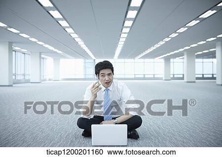 a businessman thinking while using laptop on the floor of an empty room View Large Photo Image Stock Image - a businessman thinking while using laptop on the floor of an empty room. Fotosearch