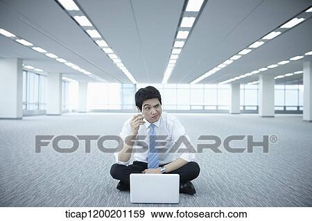 a businessman thinking while using laptop on the floor of an empty room View Large Photo Image Stock Photo - a businessman thinking while using laptop on the floor of an empty room. Fotosearch