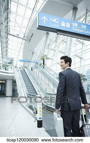 a businessman watching with a luggage in a Incheon airport View Large Photo Image Stock Image - a businessman watching with a luggage in a Incheon airport . Fotosearch