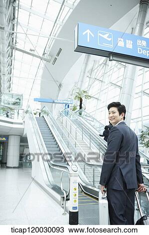 a businessman watching with a luggage in a Incheon airport View Large Photo Image Stock Image - a businessman watching with a luggage in a Incheon airport . Fotosearch