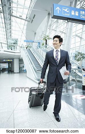 a businessman watching with a luggage in a Incheon airport View Large Photo Image Stock Photo - a businessman watching with a luggage in a Incheon airport . Fotosearch