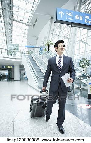 a businessman watching with a luggage in a Incheon airport View Large Photo Image Stock Photograph - a businessman watching with a luggage in a Incheon airport . Fotosearch