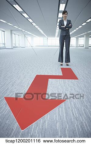 a businesswoman standing in front of an arrow in an empty room View Large Photo Image Stock Photograph - a businesswoman standing in front of an arrow in an empty room. Fotosearch