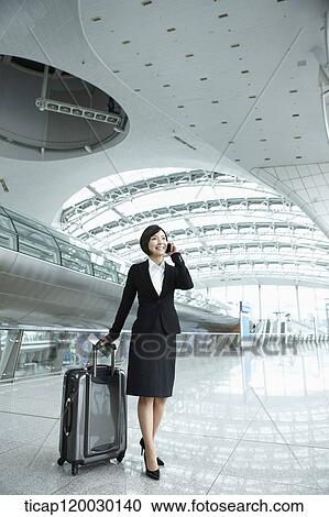 a businesswoman talking on the phone in Incheon airport View Large Photo Image Stock Image - a businesswoman talking on the phone in Incheon airport. Fotosearch