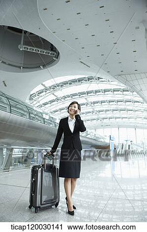 a businesswoman talking on the phone in Incheon airport View Large Photo Image Stock Image - a businesswoman talking on the phone in Incheon airport. Fotosearch