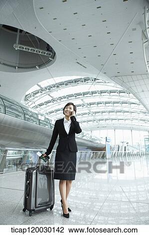 a businesswoman talking on the phone in Incheon airport View Large Photo Image Stock Image - a businesswoman talking on the phone in Incheon airport. Fotosearch