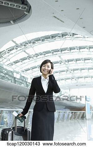 a businesswoman talking on the phone in Incheon airport View Large Photo Image Stock Image - a businesswoman talking on the phone in Incheon airport. Fotosearch