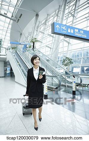 a businesswoman walking in a Incheon airport with a luggage View Large Photo Image Stock Photo - a businesswoman walking in a Incheon airport with a luggage. Fotosearch