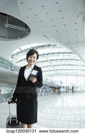 a businesswoman walking with luggage in Incheon airport View Large Photo Image Stock Image - a businesswoman walking with luggage in Incheon airport. Fotosearch