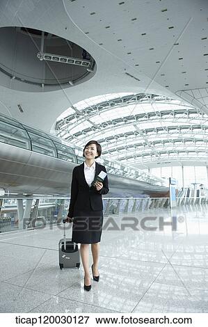 a businesswoman walking with luggage in Incheon airport View Large Photo Image Stock Photo - a businesswoman walking with luggage in Incheon airport. Fotosearch