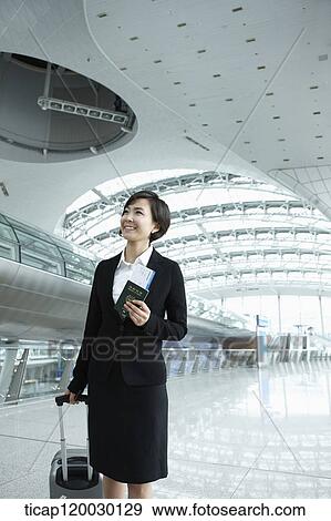 a businesswoman walking with luggage in Incheon airport View Large Photo Image Stock Photo - a businesswoman walking with luggage in Incheon airport. Fotosearch