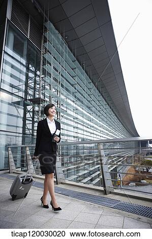 a businesswoman with a luggage and a passport walking in Incheon airport View Large Photo Image Stock Image - a businesswoman with a luggage and a passport walking in Incheon airport. Fotosearch