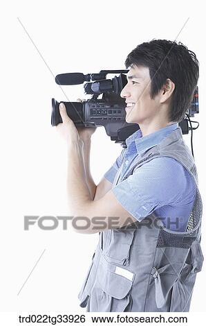 a cameraman standing in sideway in white background View Large Photo Image Stock Photograph - a cameraman standing in sideway in white background . Fotosearch