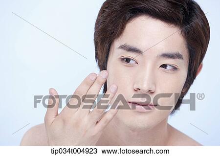a close up shot of a topless man about to put on lotion View Large Photo Image Stock Image - a close up shot of a topless man about to put on lotion. Fotosearch