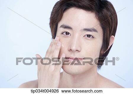 a close up shot of a topless man putting on lotion View Large Photo Image Stock Photograph - a close up shot of a topless man putting on lotion. Fotosearch