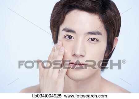 a close up shot of a topless man putting on lotion View Large Photo Image Stock Photography - a close up shot of a topless man putting on lotion. Fotosearch