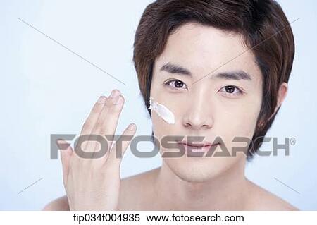 a close up shot of a topless man putting on white cream lotion View Large Photo Image Stock Photography - a close up shot of a topless man putting on white cream lotion. Fotosearch