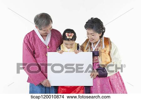 a couple and grand child holding a white board together View Large Photo Image Picture - a couple and grand child holding a white board together . Fotosearch
