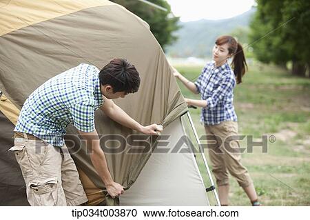 a couple building a tent View Large Photo Image Stock Image - a couple building a tent. Fotosearch